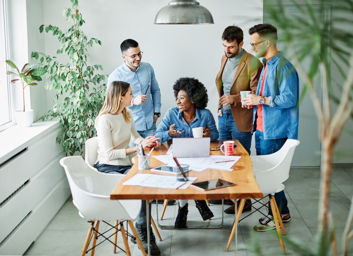 A project team mapping processes together around a table