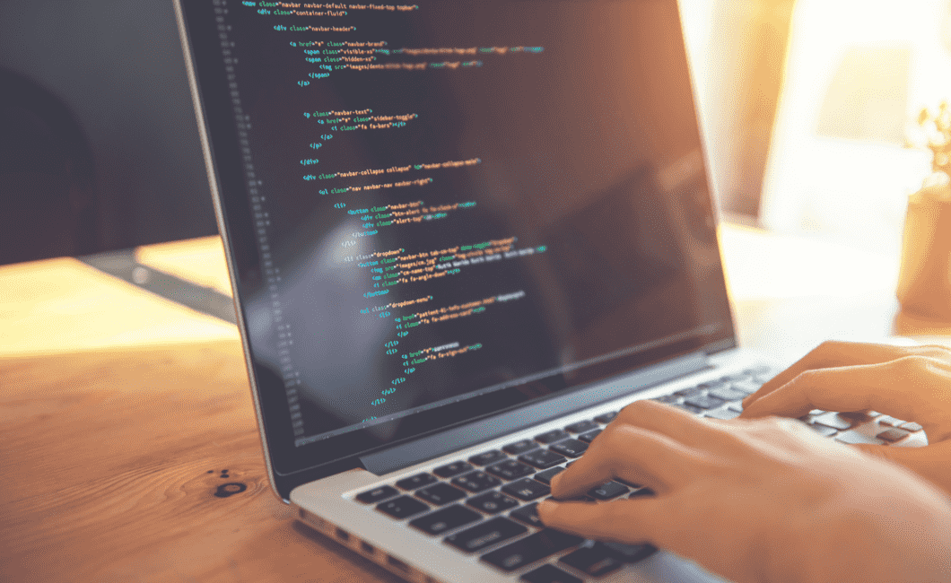 Developer writing front-end code on a laptop