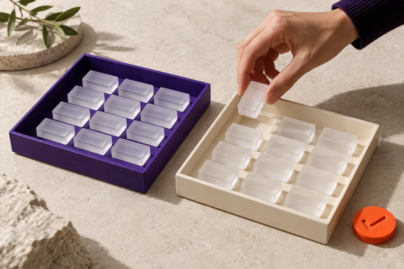 A hand transfers a frosted data token between organised trays, illustrating careful data movement.