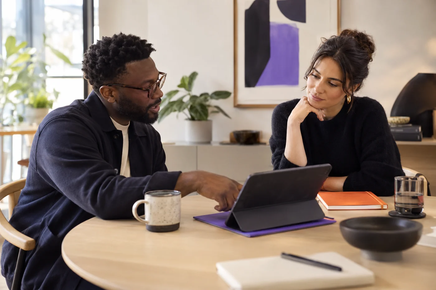 A sales colleague reviews information at a desk.