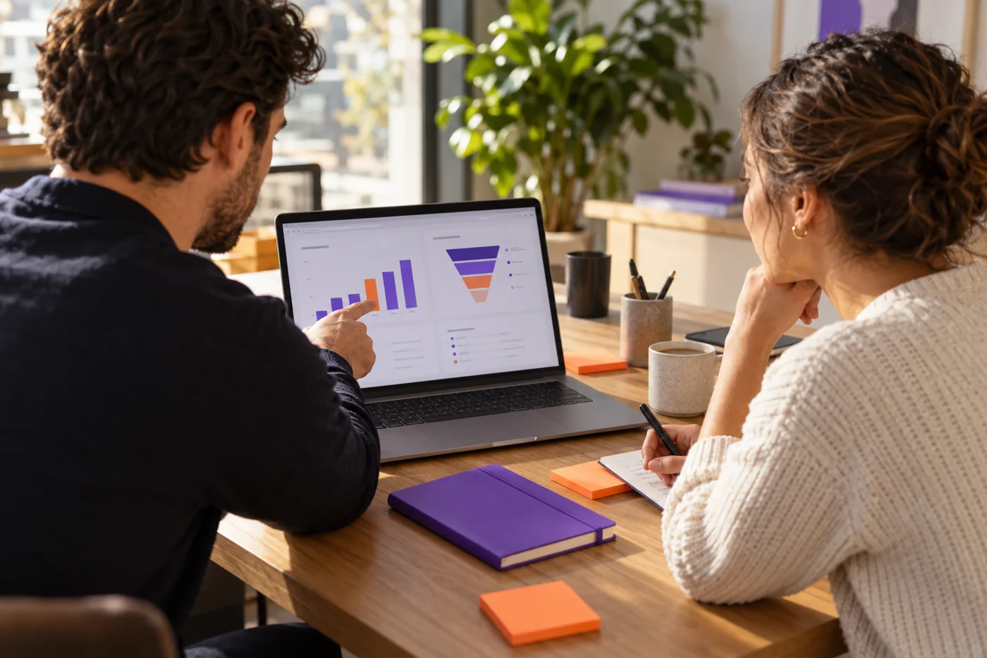 Sales colleagues review illustrative charts while planning opportunities.
